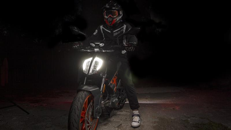 Motorcycle with lit LED headlight at night