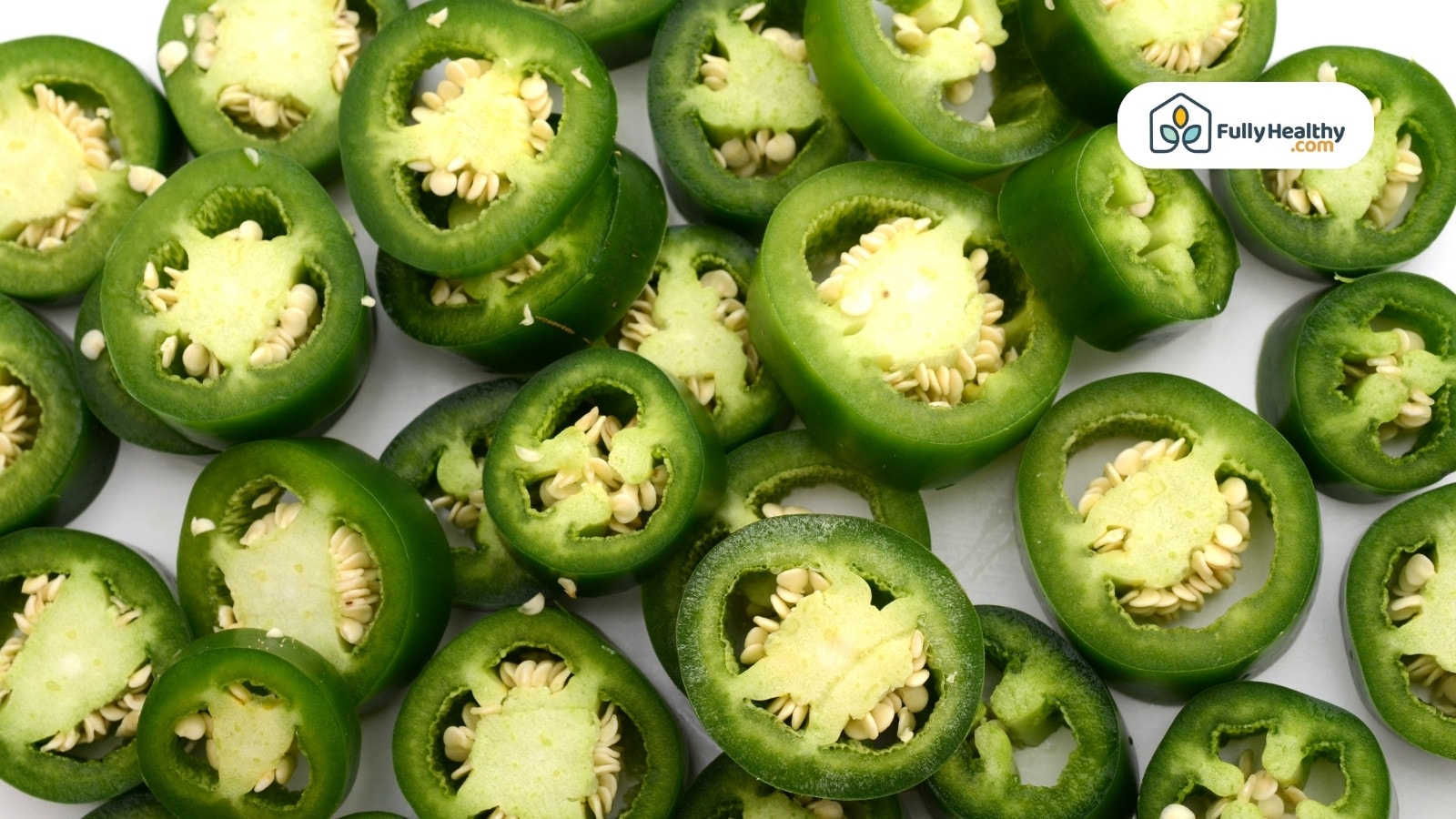 Sliced jalapeño peppers showing seeds and vibrant green color