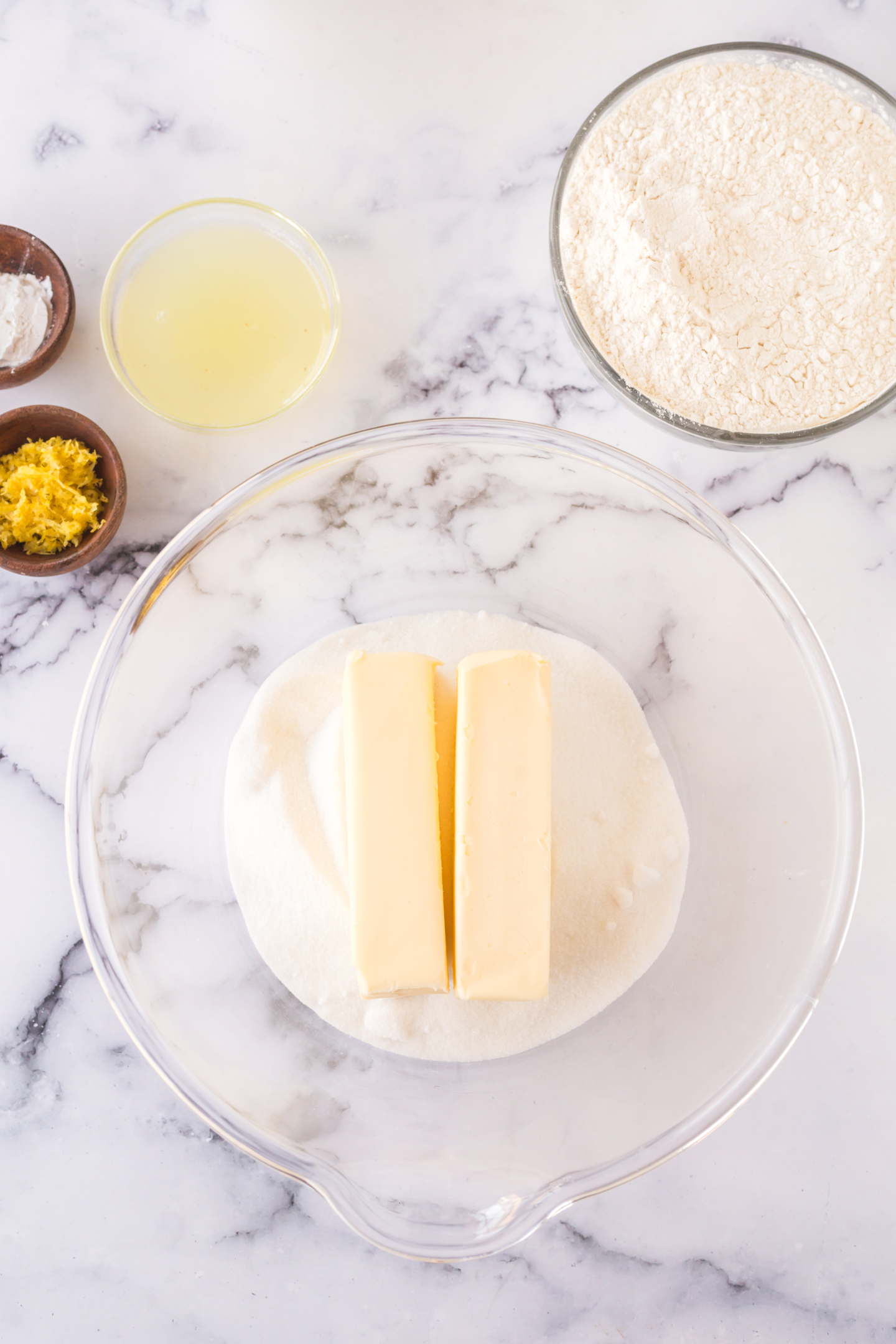 two sticks of butter and sugar in a bowl