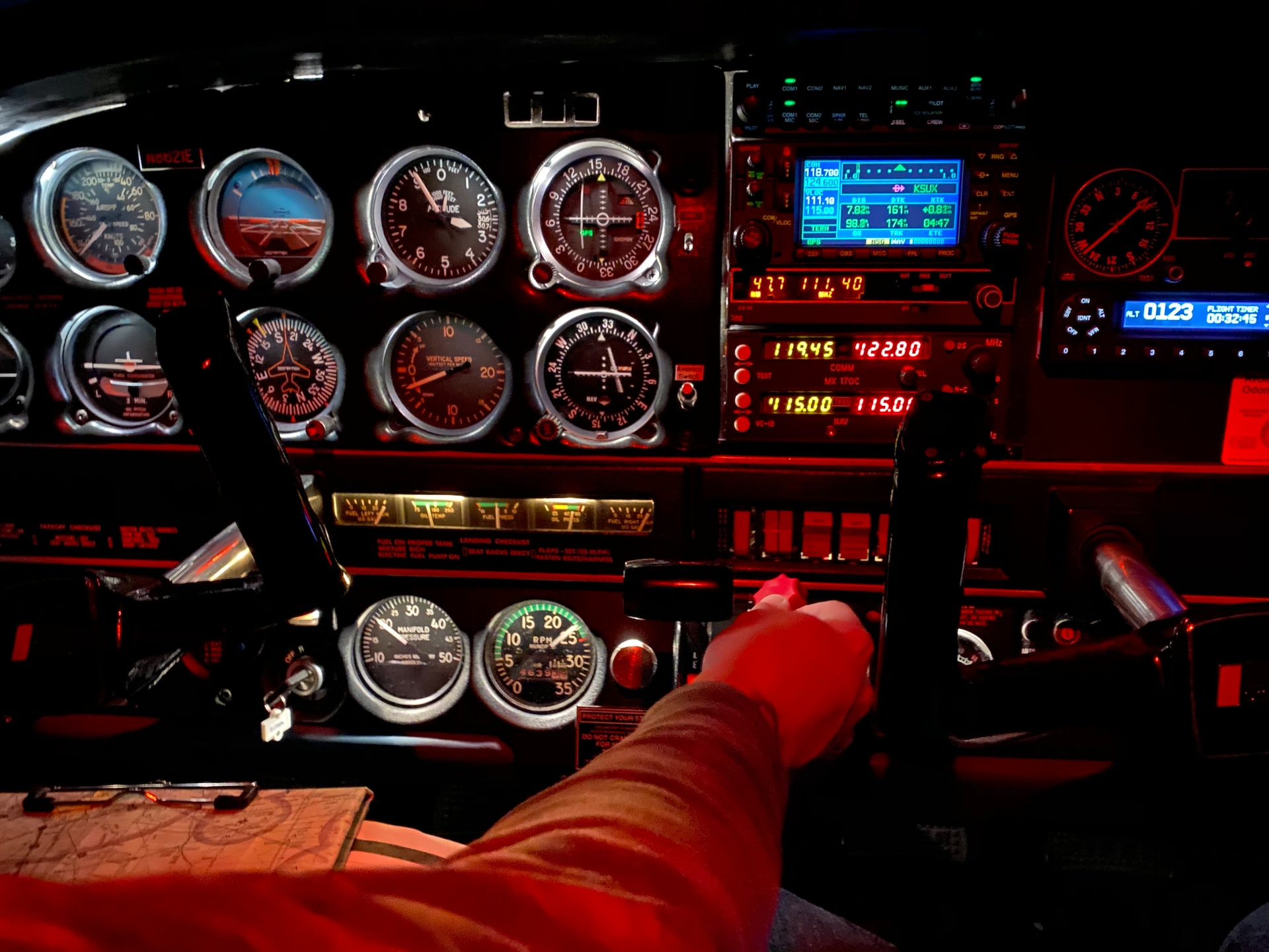 A pilot in command adjusting flight controls.