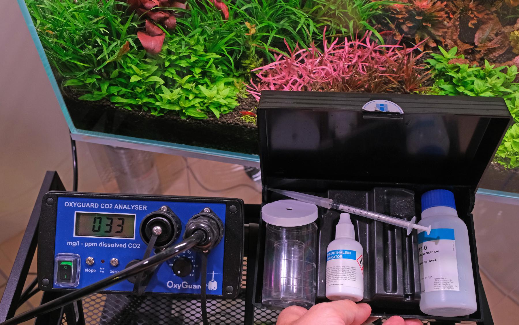 Liquid and electronic CO2 measuring kits in front of aquarium