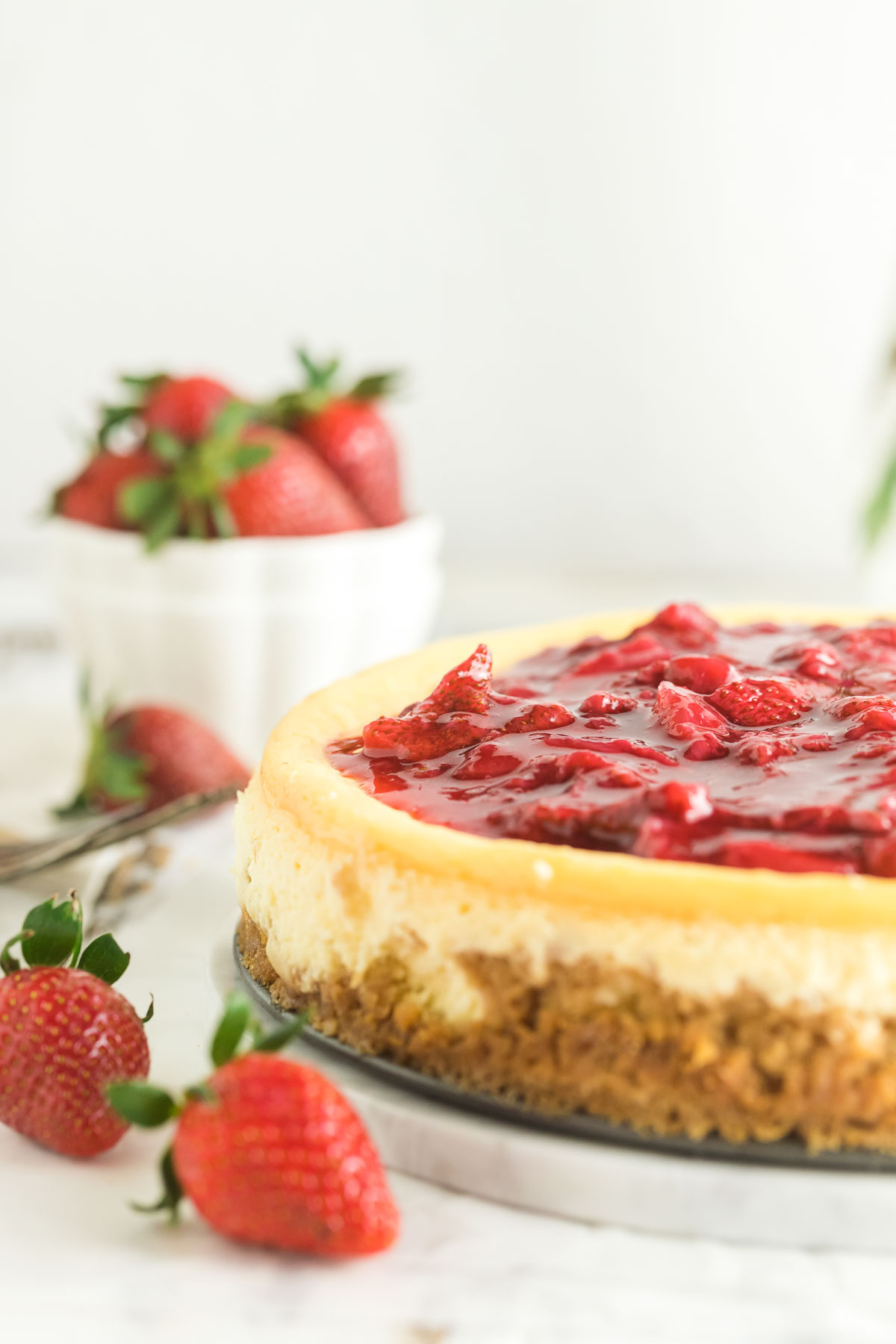 side view of cheesecake with strawberry topping
