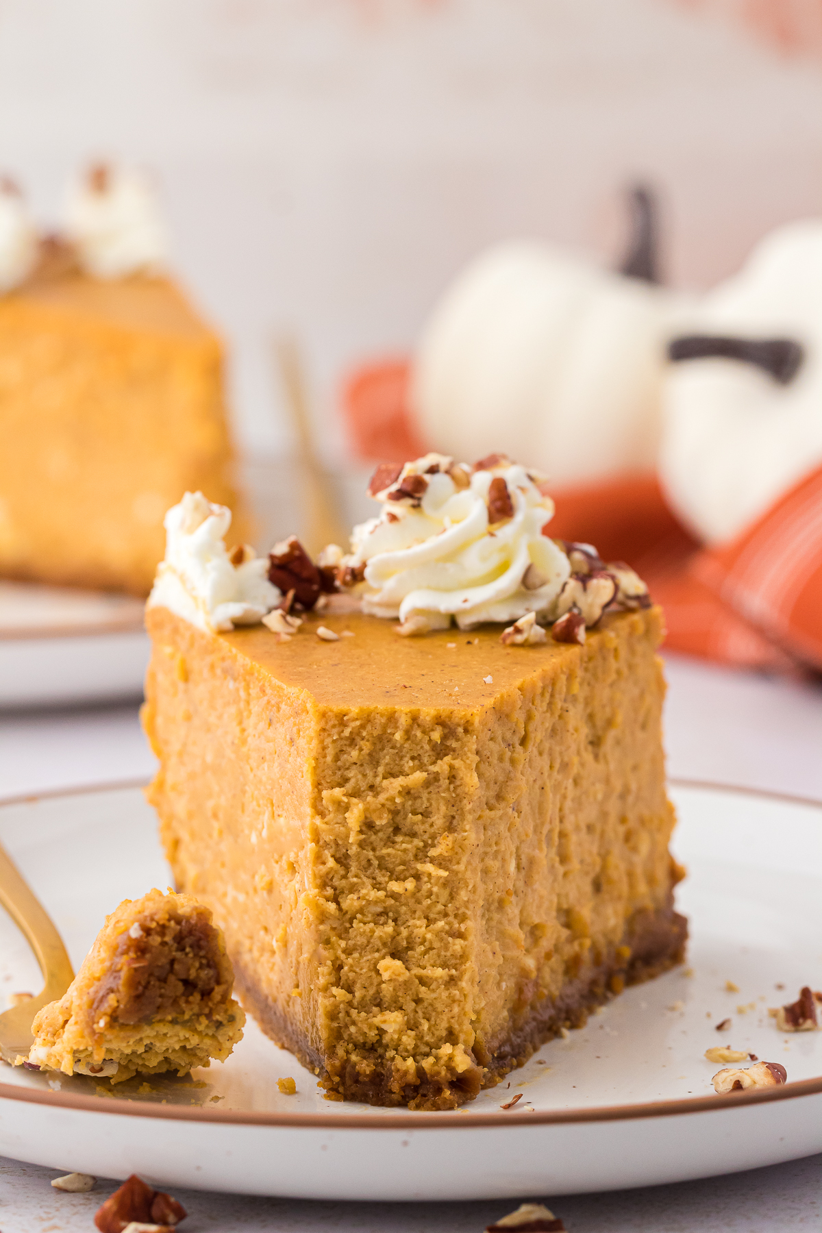 slice of pumpkin cheesecake on a plate with a fork