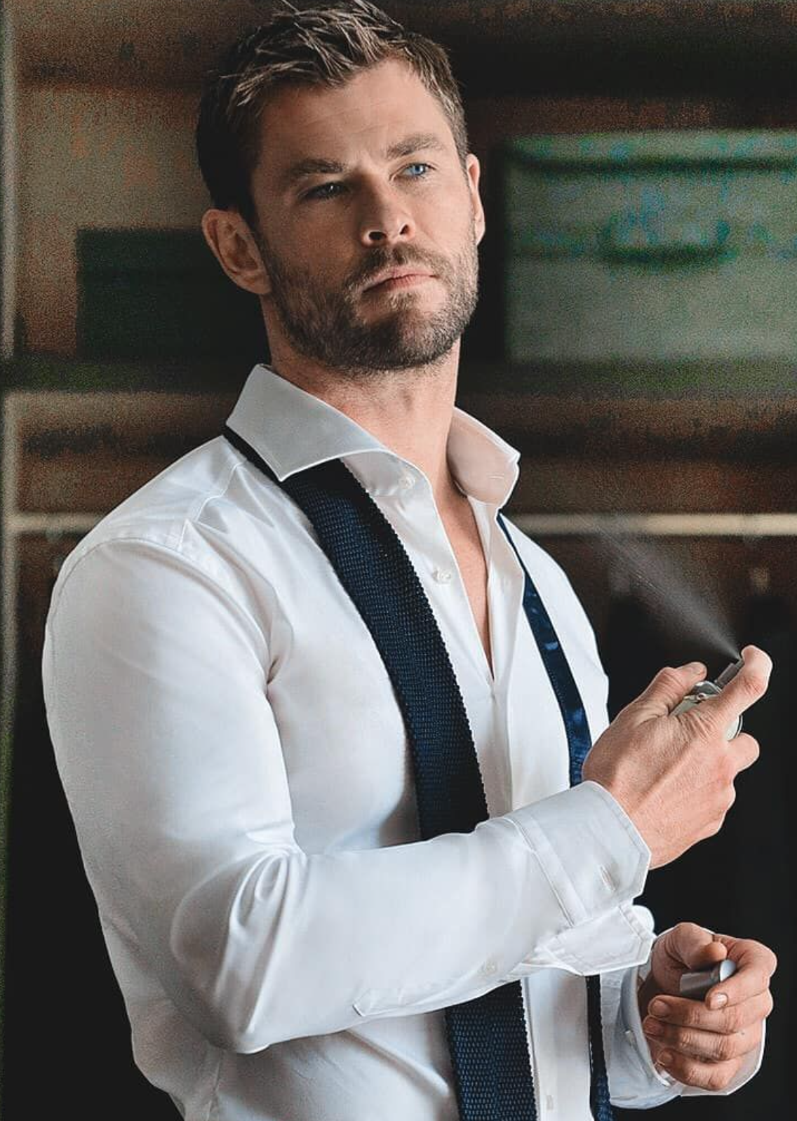 Chris Hemsworth applying cologne