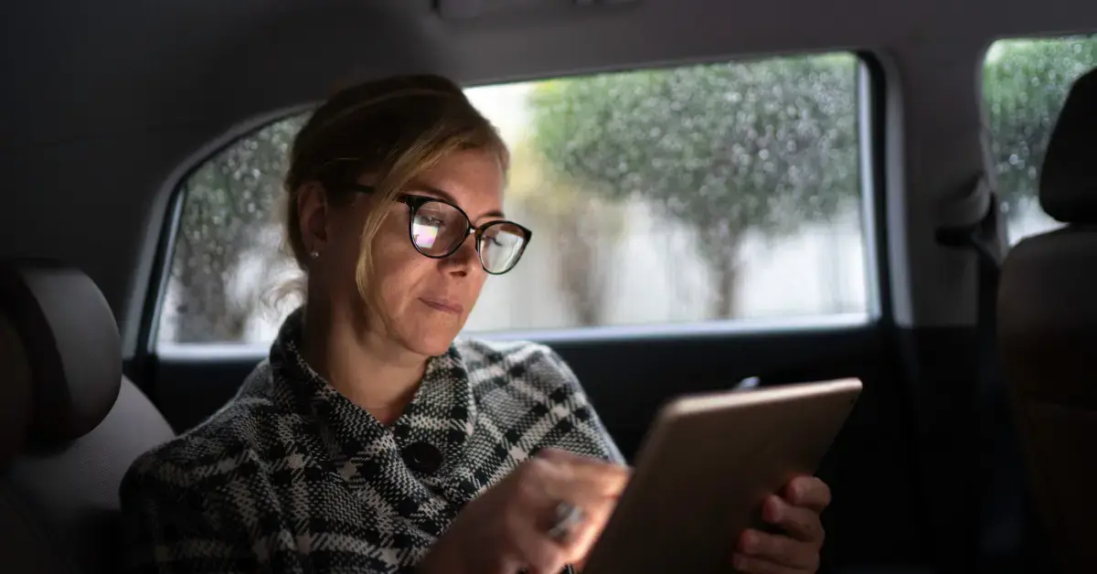 Woman reading an IRS notice in her vehicle and asking can the IRS take your car for unpaid taxes.