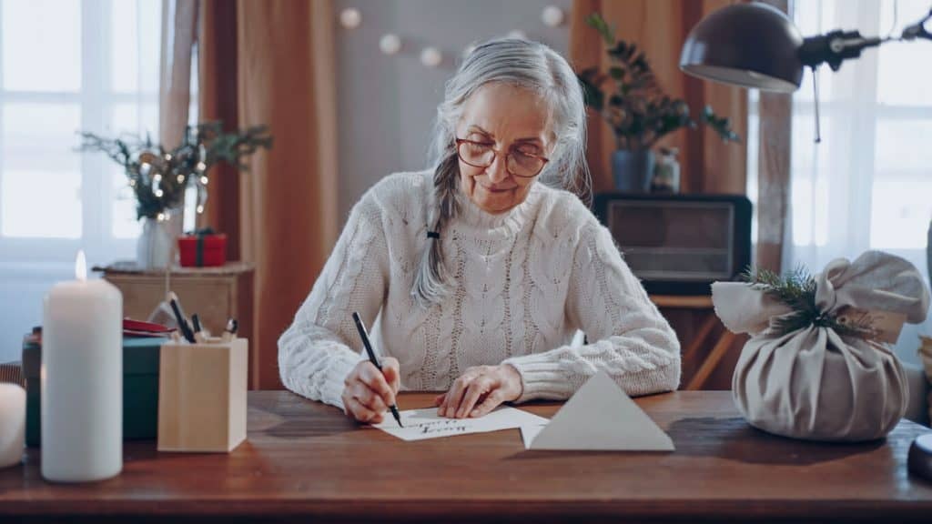  A happy senior woman writing a will at home