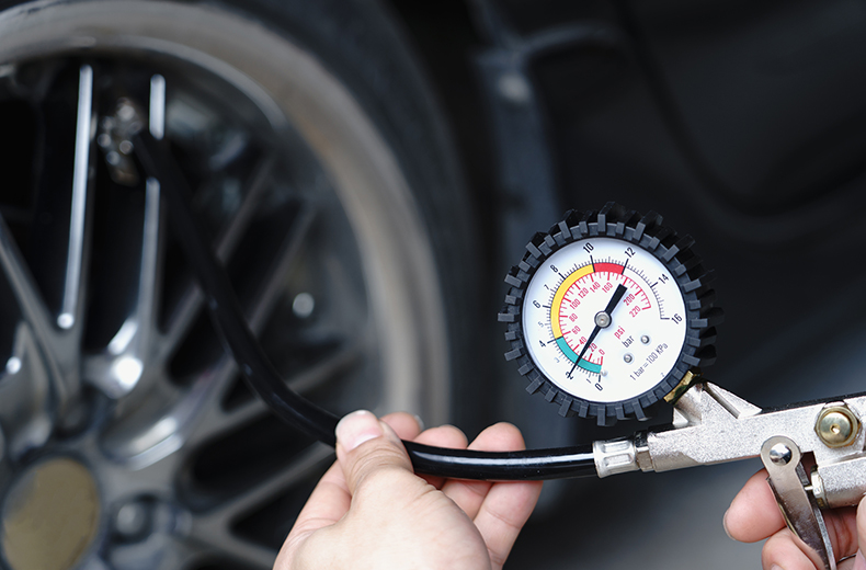 Checking tire pressure for proper vehicle maintenance