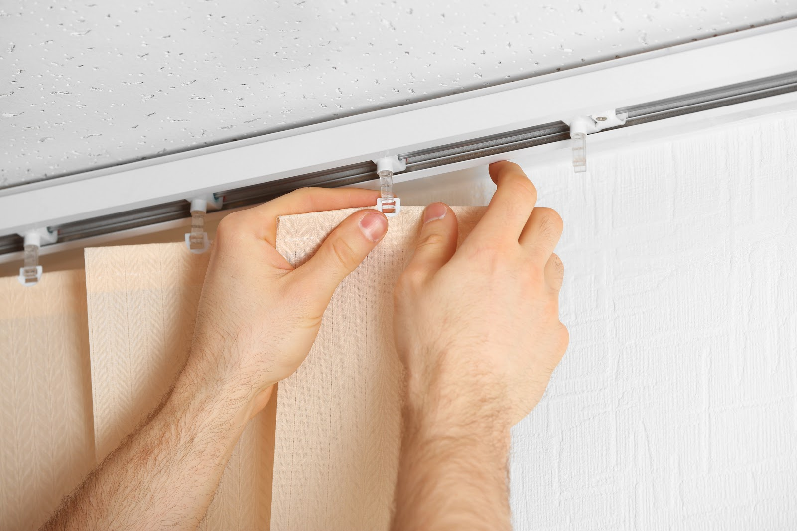 After washing blinds, lay them in a flat surface and attach them back to the headrail when they're completely dry