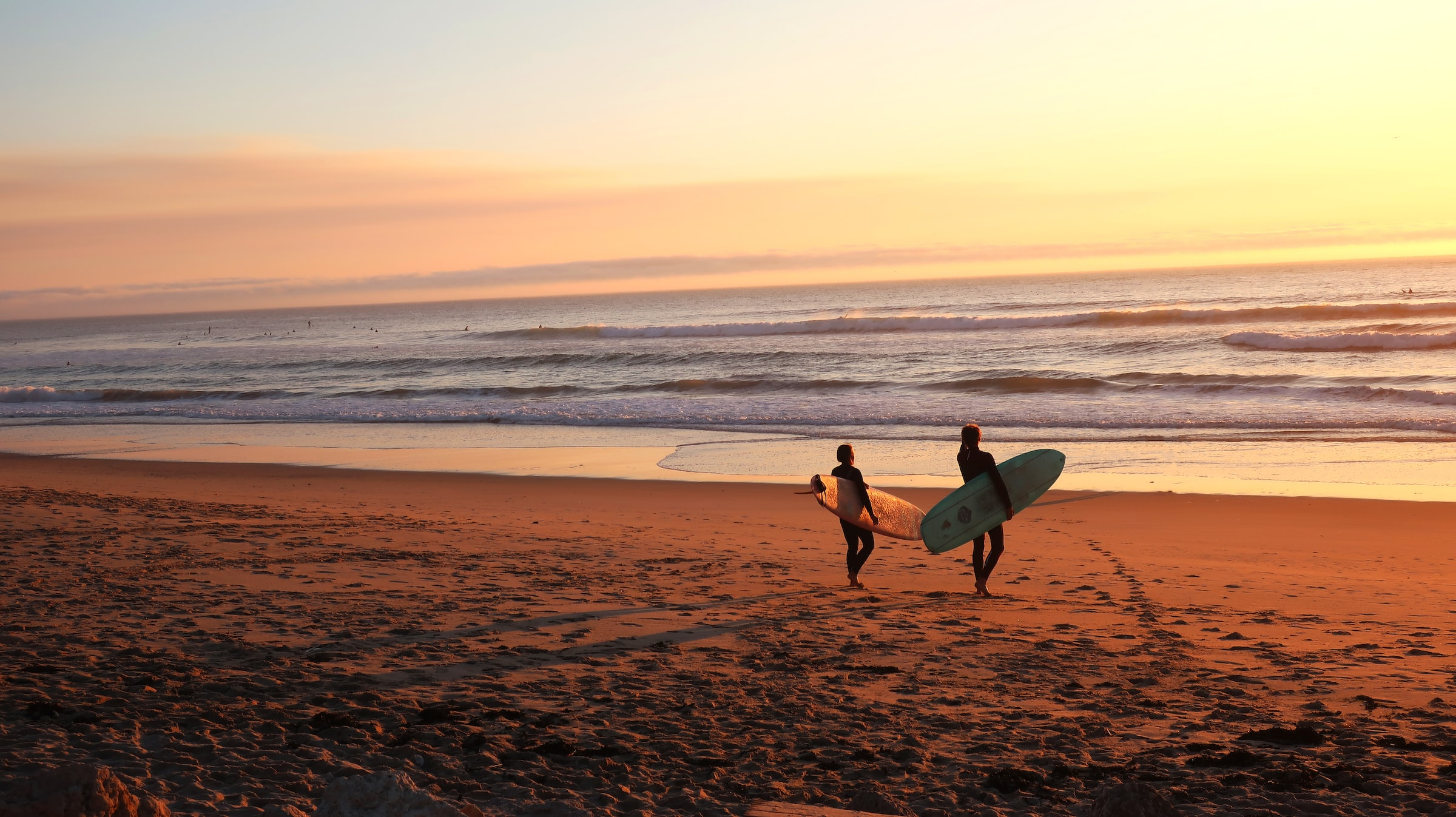 two surfers on the beach 