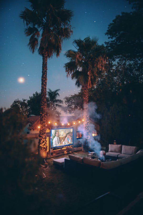 projector screen set outdoors at night in front of a couch