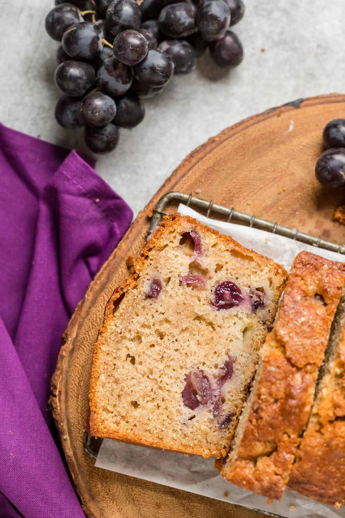 sliced graped quick bread on a cooling rack