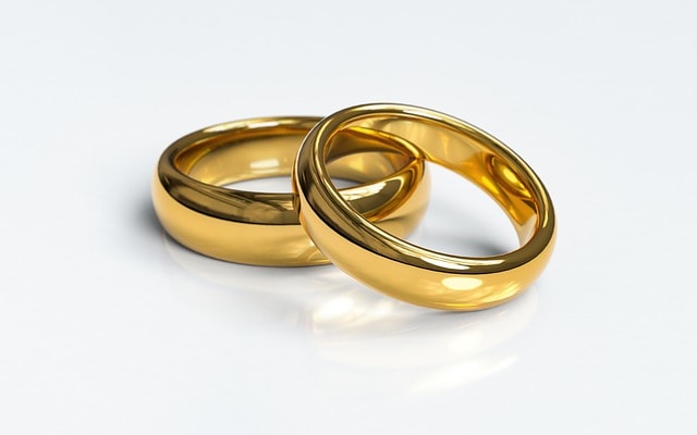 Two gold wedding rings on top of each other