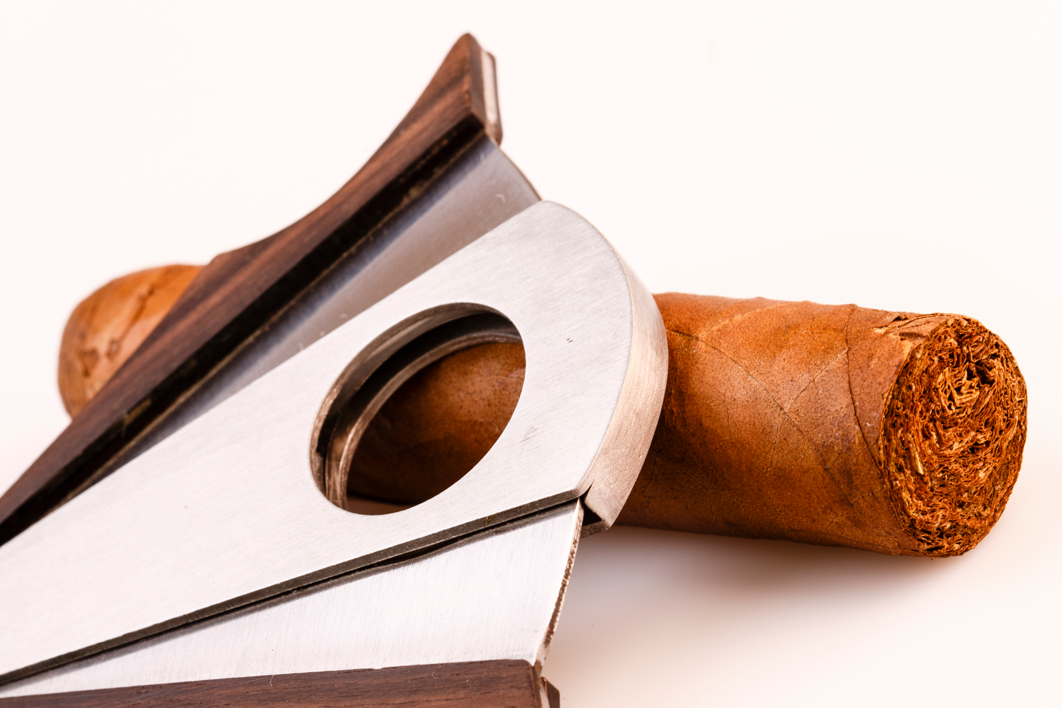 A selection of different cigar cutters with different shapes and bits