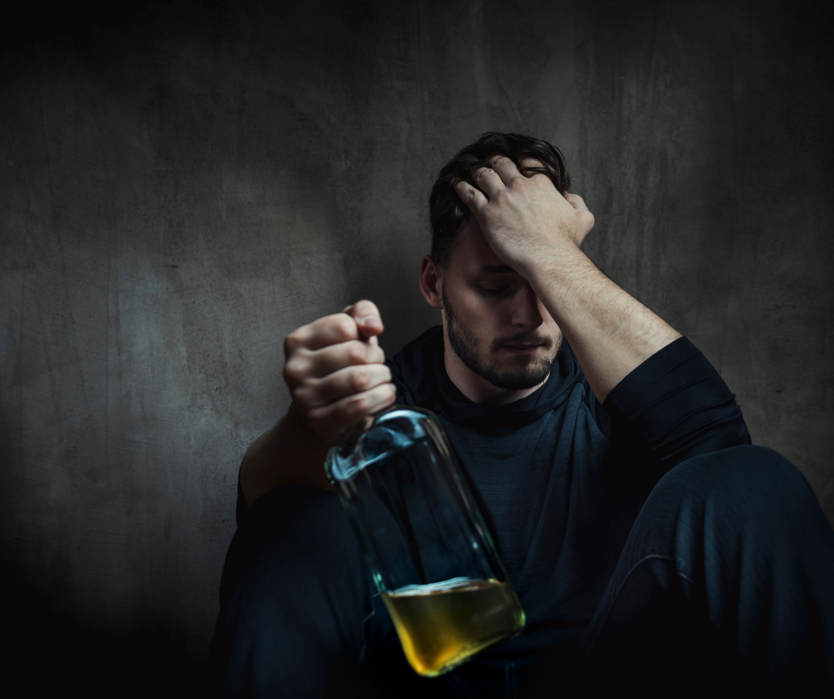 An image showing a person holding their head, possibly experiencing brain fog after quitting alcohol, which raises the question of how long does brain fog last after quitting alcohol