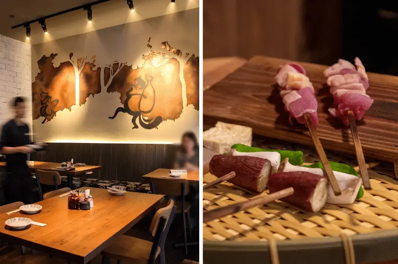 A split image displaying a modern izakaya dining room illuminated by a backlit wall mural of silhouetted figures on the left, alongside a close-up of colorful, uncooked vegetable and meat skewers resting on a bamboo mat on the right.