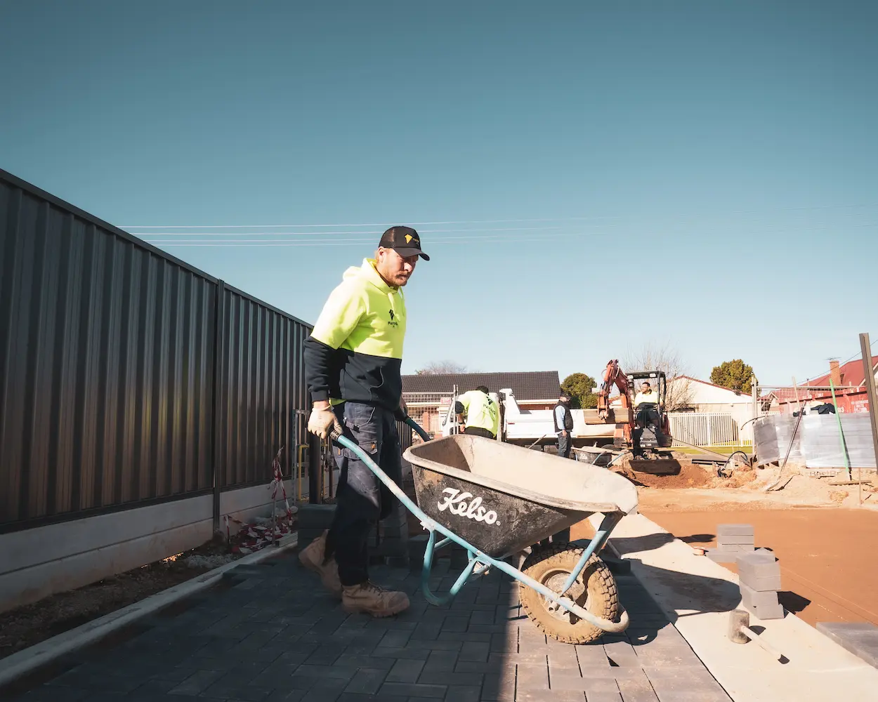 A person sealing the pavers with a sealant