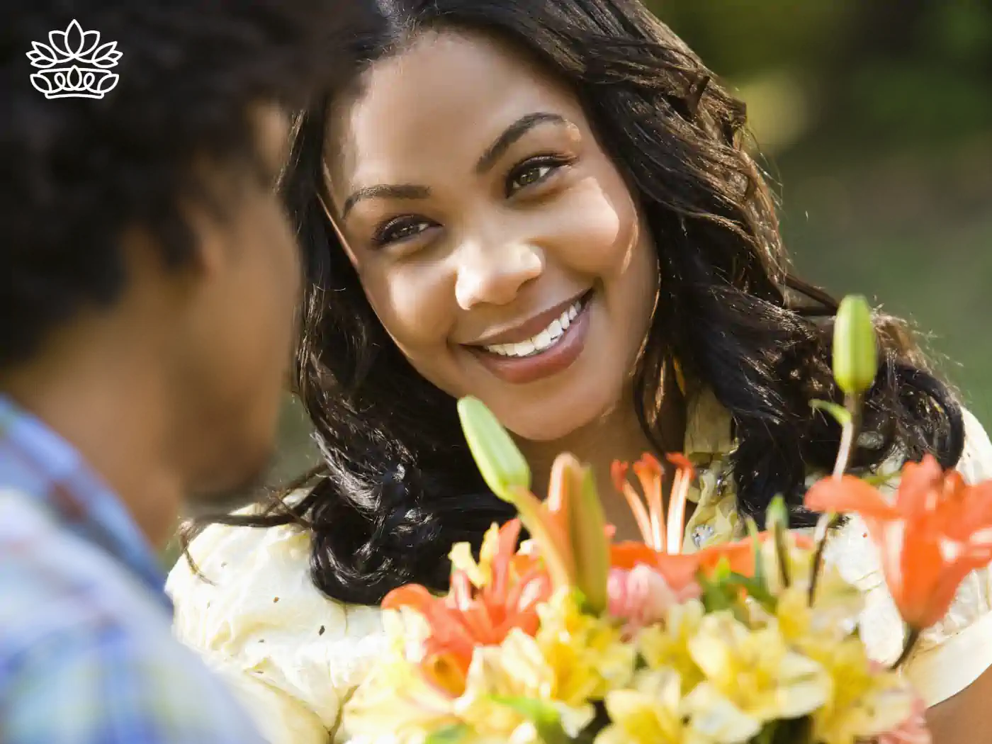 Happy woman receiving a colourful floral bouquet from a man outdoors. Fabulous Flowers and Gifts, Luxury Flower Arrangements.