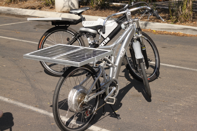 What is the minimum number of solar panels required to charge an electric bike?