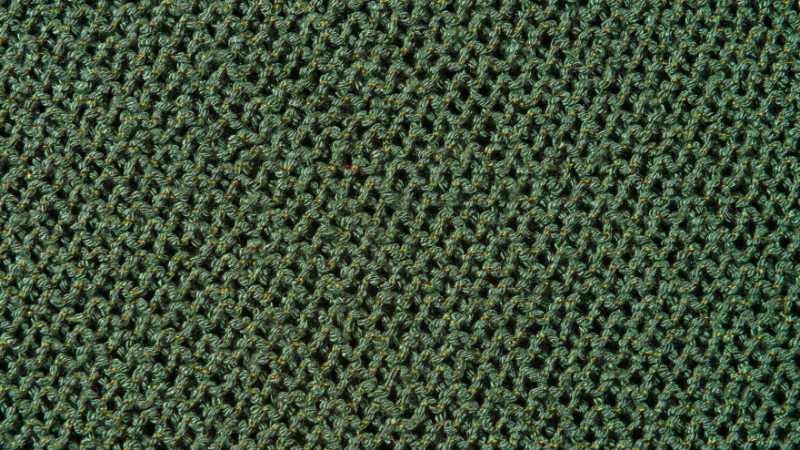 A close up image of a green twill fabric
