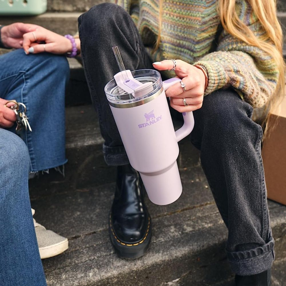 A person holding a Pink Stanley Tumbler with Quencher H2.0 Flowstate Technology
