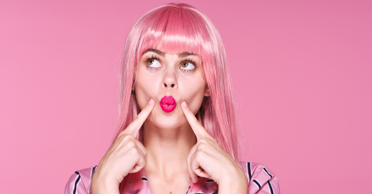 Sexy woman ponders what is QBI deduction for OnlyFans income while posing in a pink outfit.
