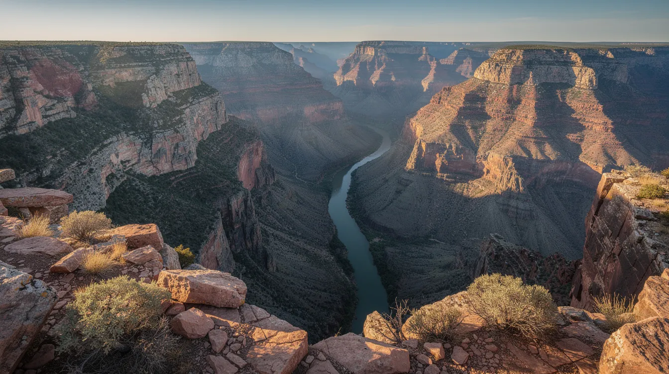 The image captures a breathtaking view from a high rocky overlook, showcasing the deep green and red hues of Zion Canyon, with towering sandstone cliffs framing the scene. Below, the winding Virgin River snakes through the canyon floor, offering a glimpse of the stunning landscapes that define Zion National Park.
