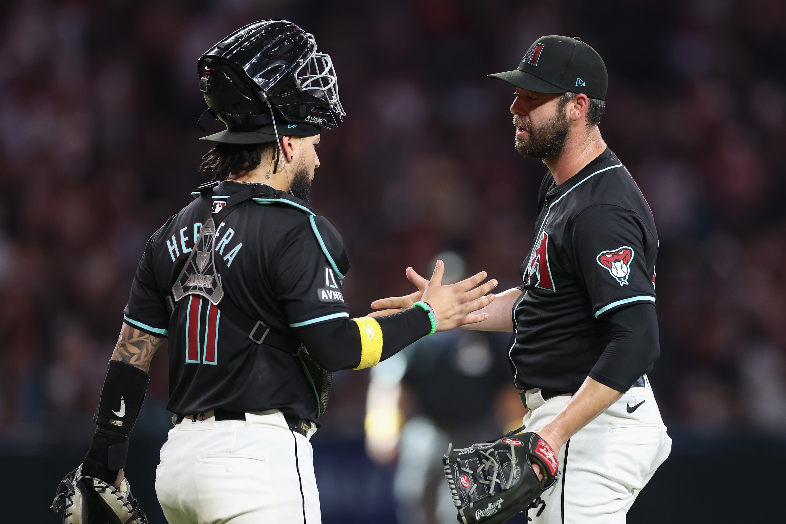  Relief pitcher Dylan Floro of the Arizona Diamondbacks celebrates with catcher Jose Herrera after defeating the Los Angeles Dodgers at Chase Field in Phoenix, Arizona. 