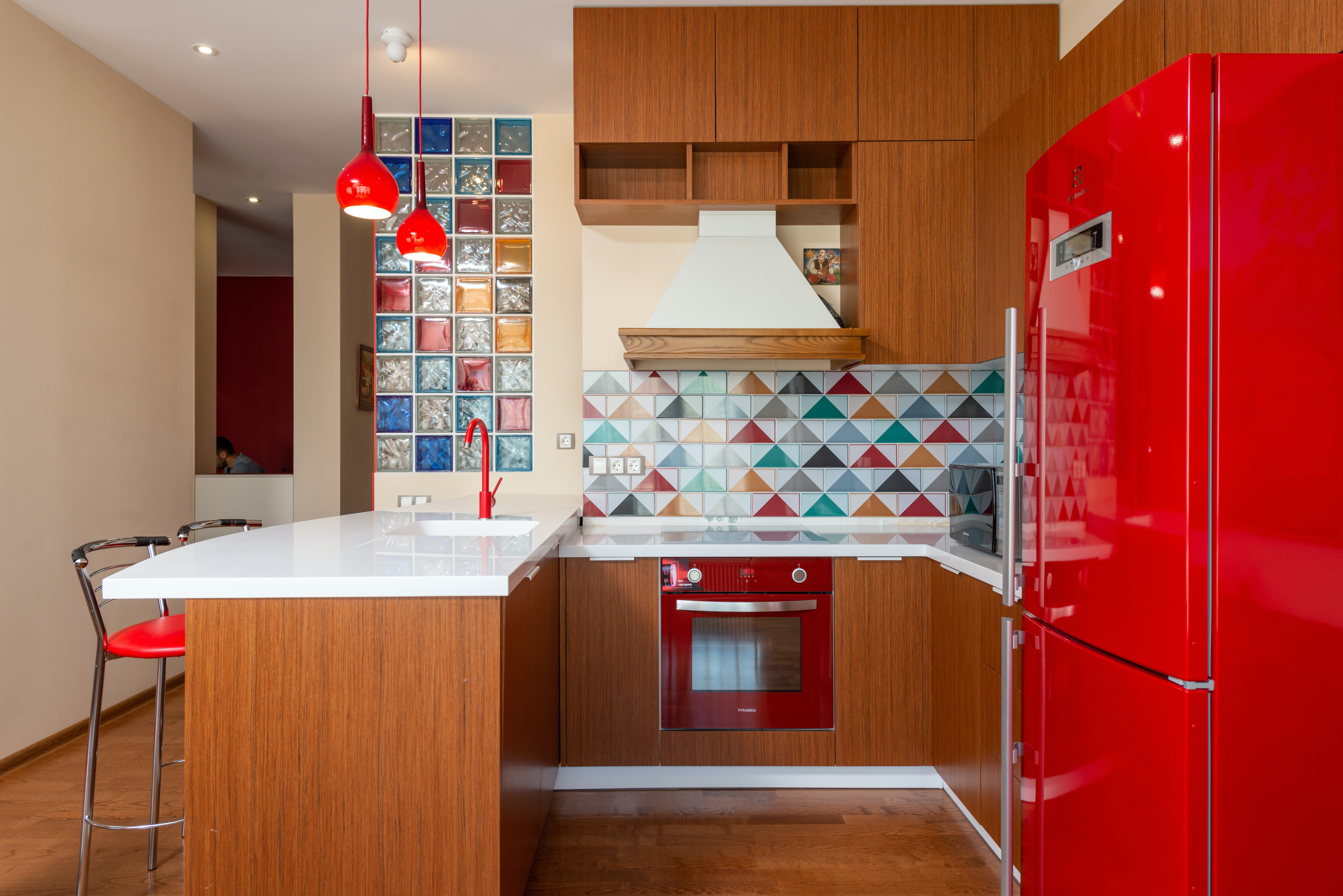 red refrigerator and stove in retro kitchen