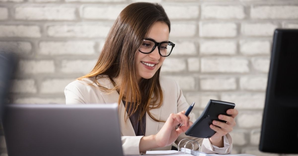 Woman calculating why is self-employment tax so high