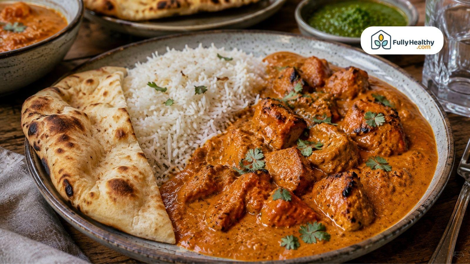 Chicken tikka masala served with basmati rice and fresh naan bread.