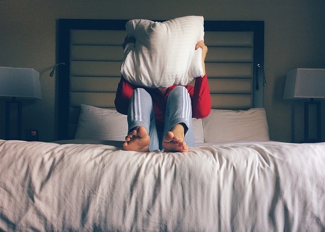person, bed, hotel, pillow, pillow, pillow, pillow, pillow, pillow