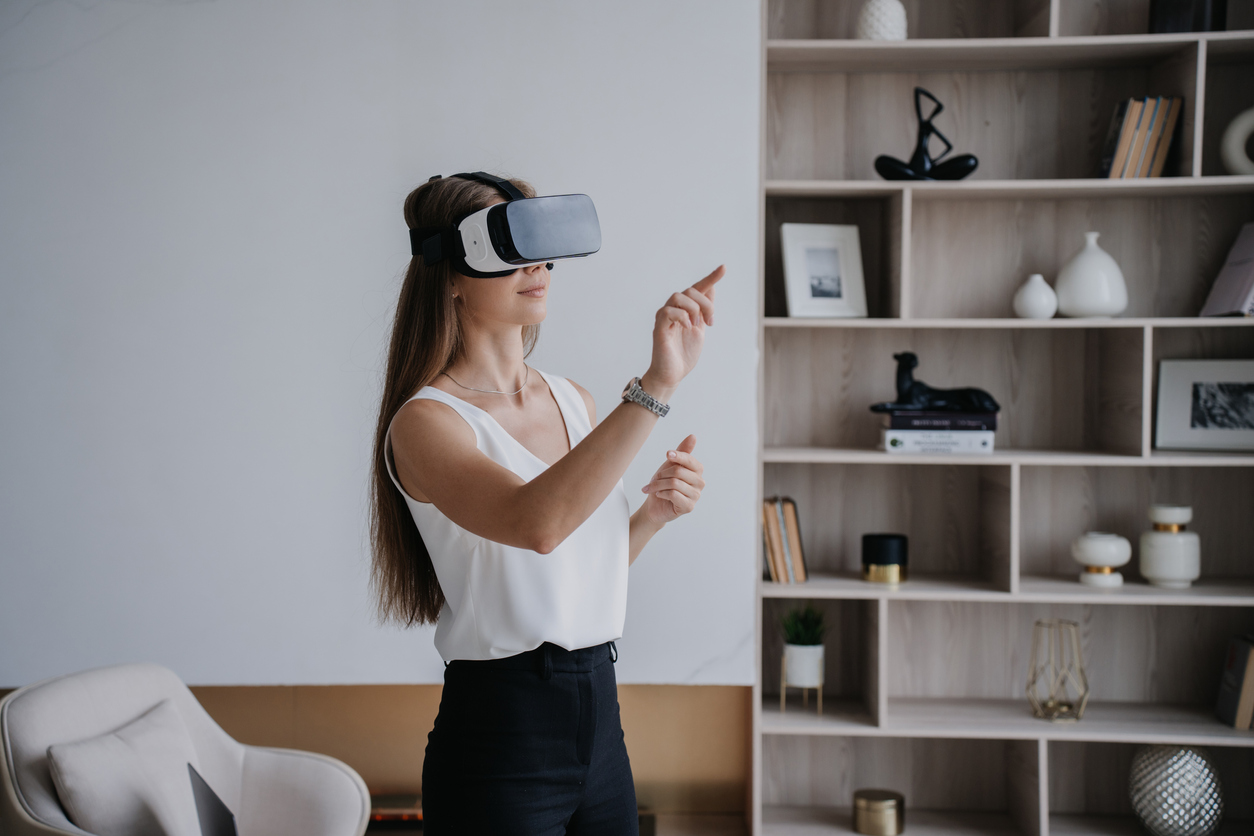 Young fit woman works remotely via virtual reality head set.