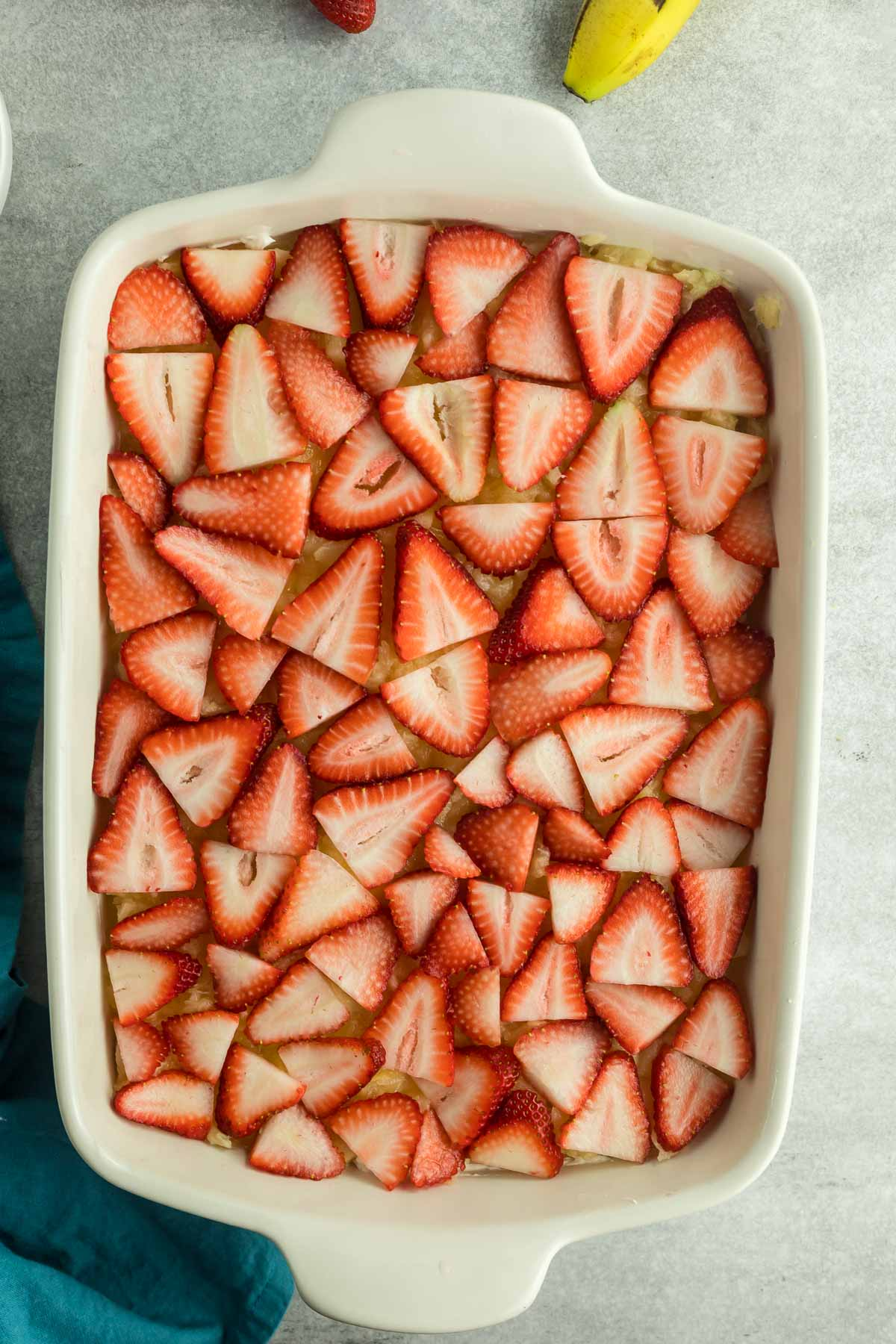 sliced strawberries on top of pineapple
