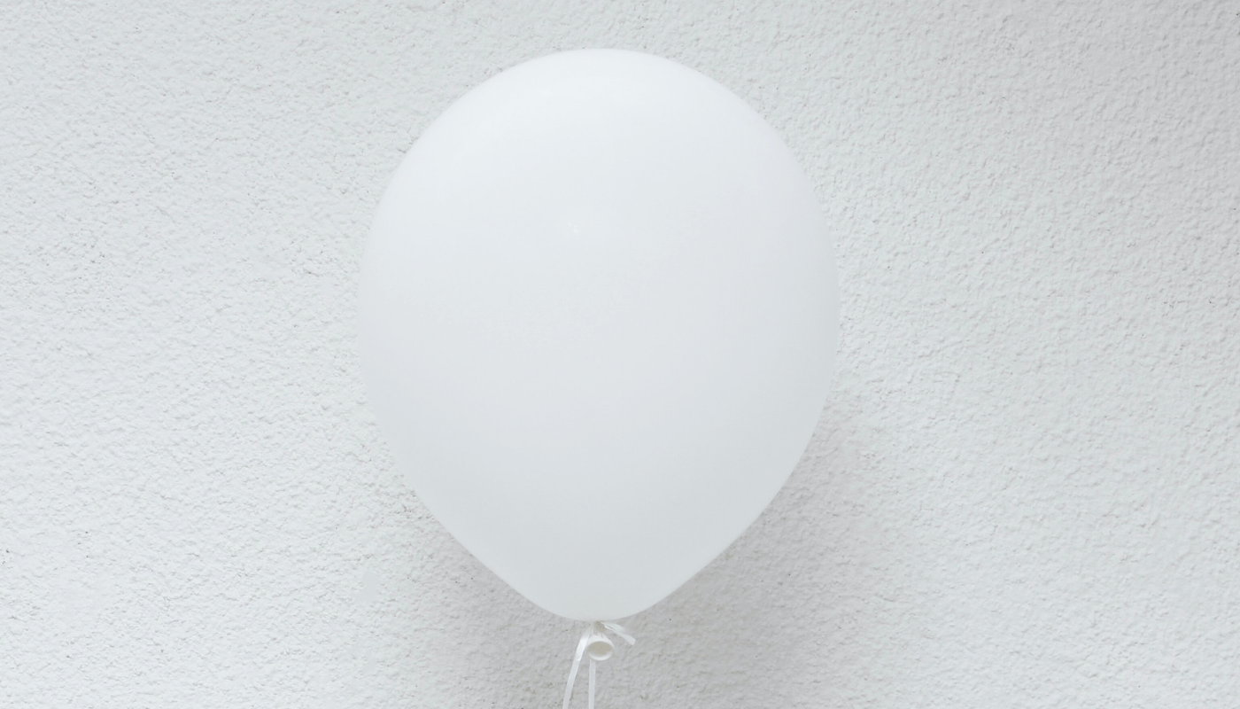 Inflated White Balloon against White Wall