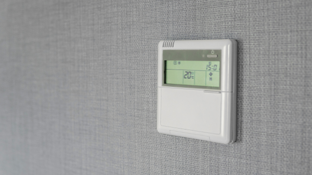 A smart temperature sensor mounted on a wall.