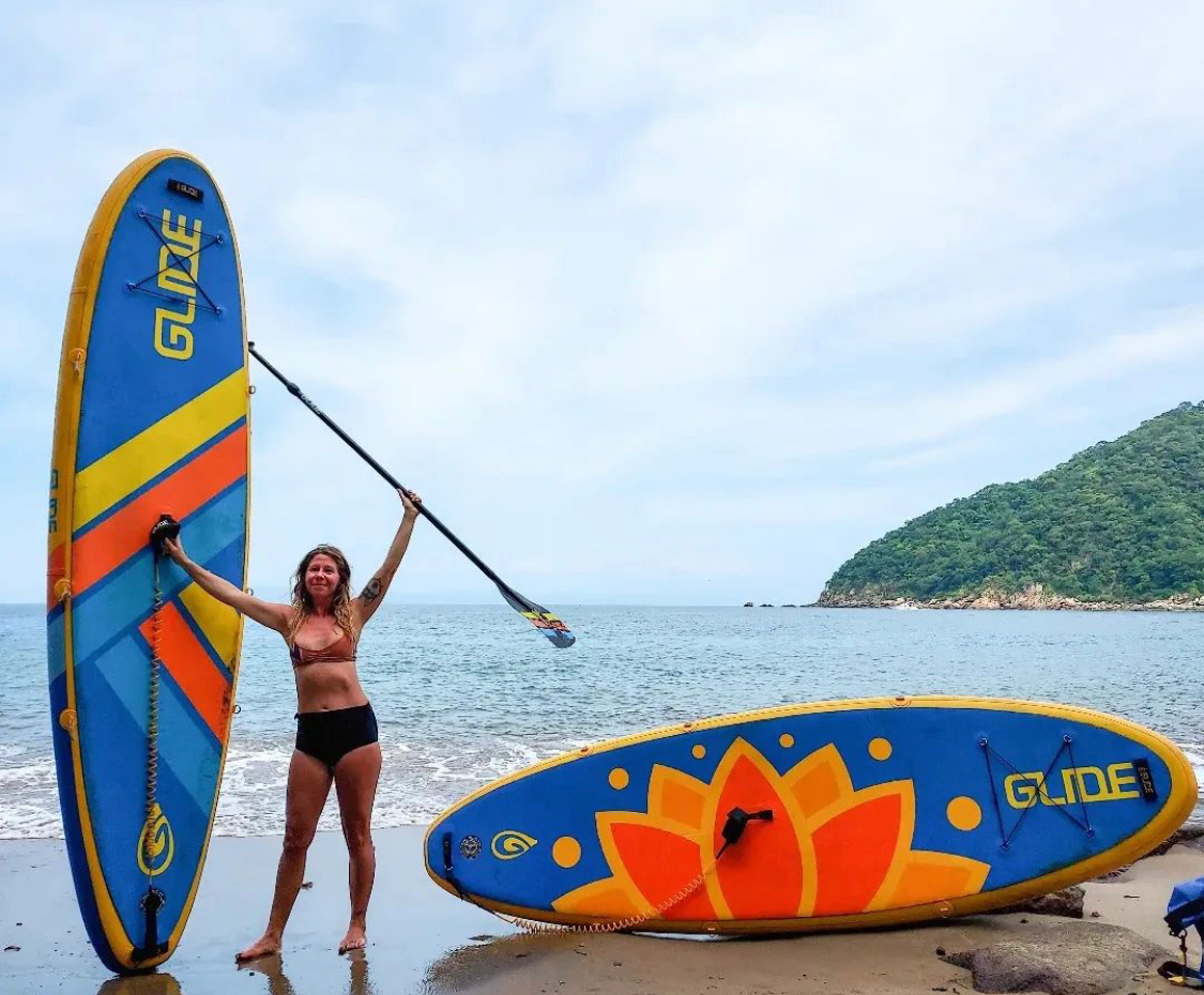 woman holding inflatable paddle board