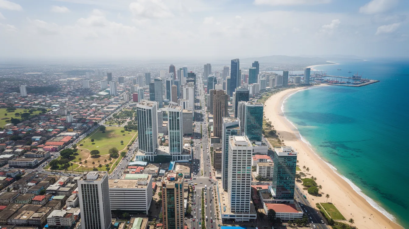 An aerial view of Dar es Salaam showcases a vibrant city skyline filled with modern high-rise buildings against the backdrop of the Indian Ocean coastline. This bustling urban environment reflects the growth of banking services and financial institutions in Tanzania, including prominent names like Stanbic Bank and CRDB Bank, contributing to the country's digital transformation and financial inclusion efforts.