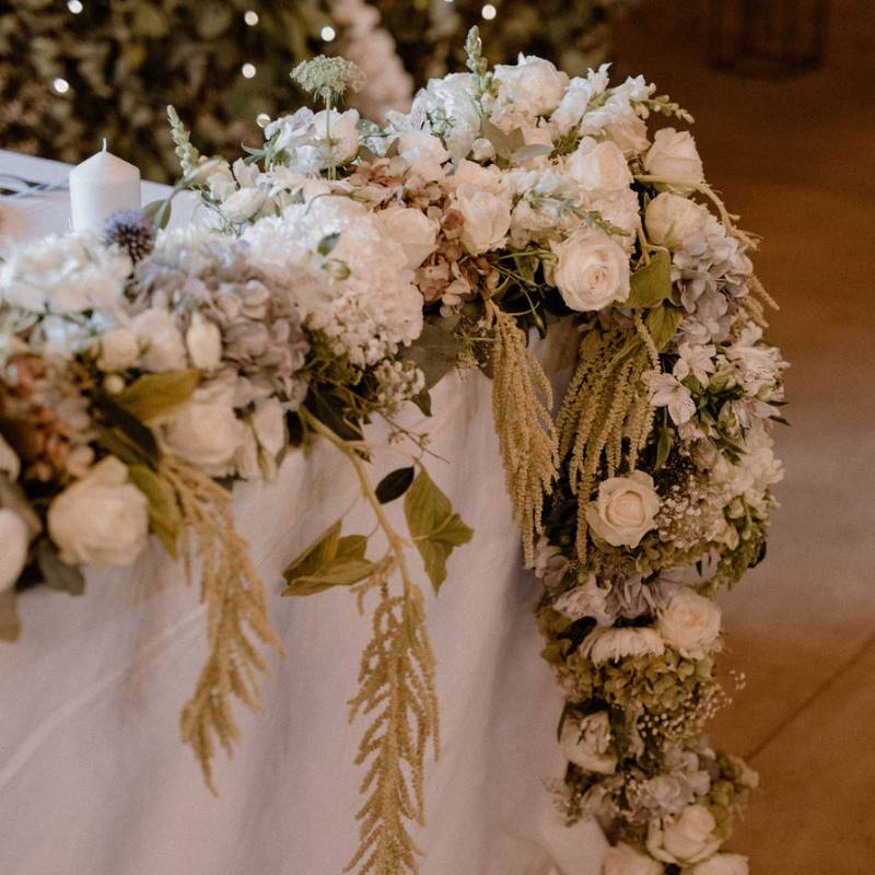 stunning arrangement, wedding flower centerpieces, pampas grass, taper candles, fresh roses