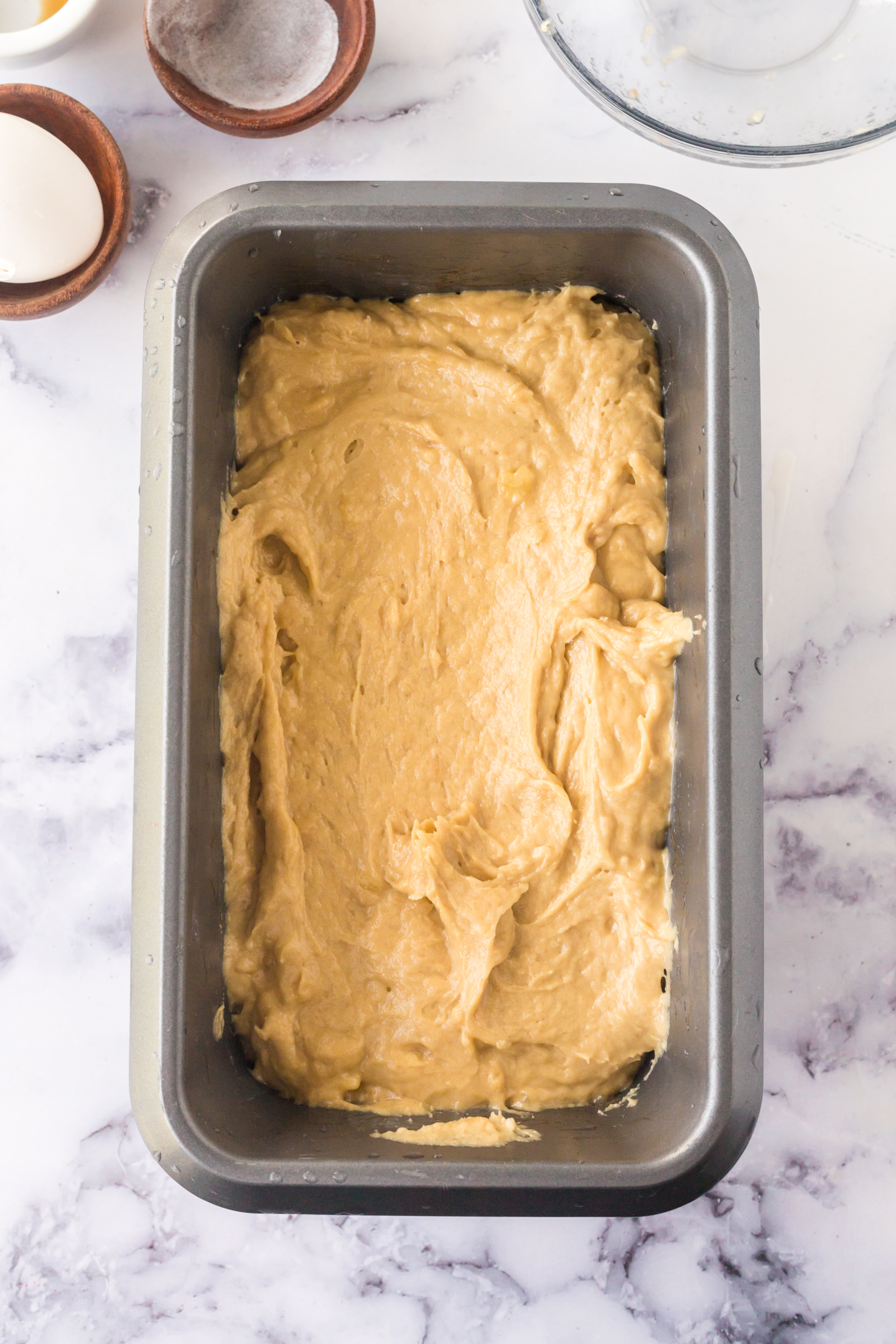 unbaked banana bread batter in a loaf pan