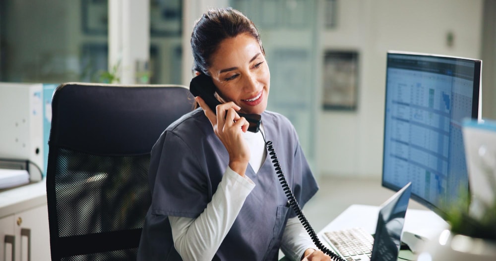 A doctor using the business phone systems to handle incoming calls from patients about test results.
