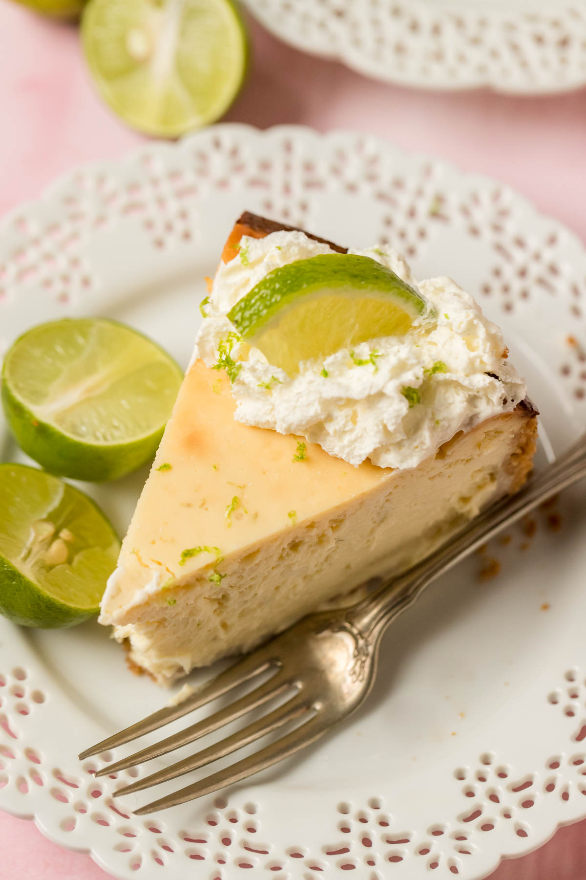 key lime cheesecake on a plate with a fork