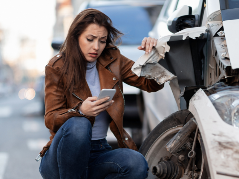 An image showing a person stressed after a car accident and contacting a lawyer in Alabama.