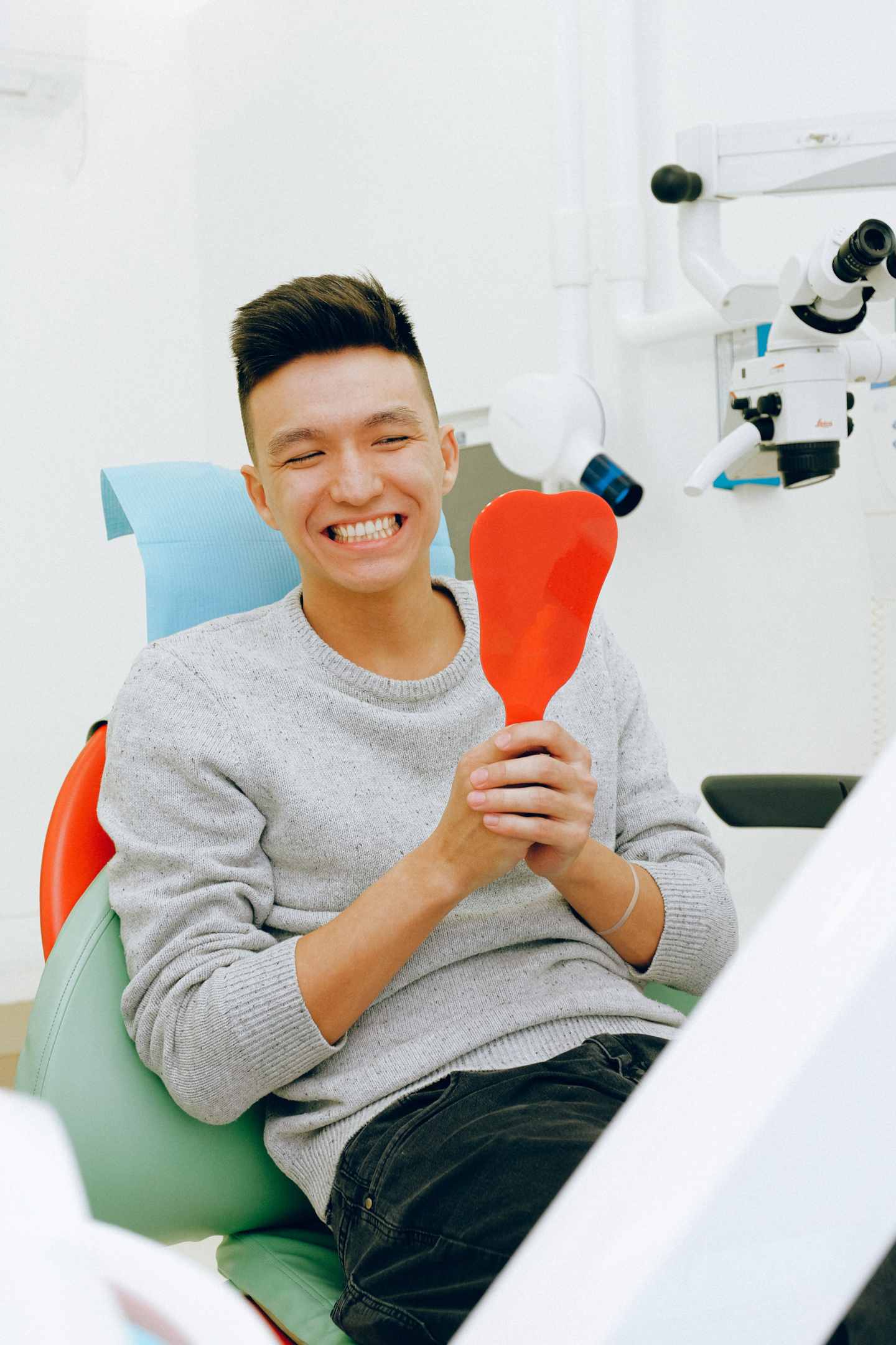 Man looking at his teeth, dental sealant