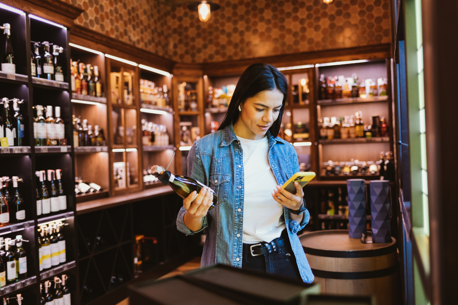 A consumer checking out a bottle of wine.