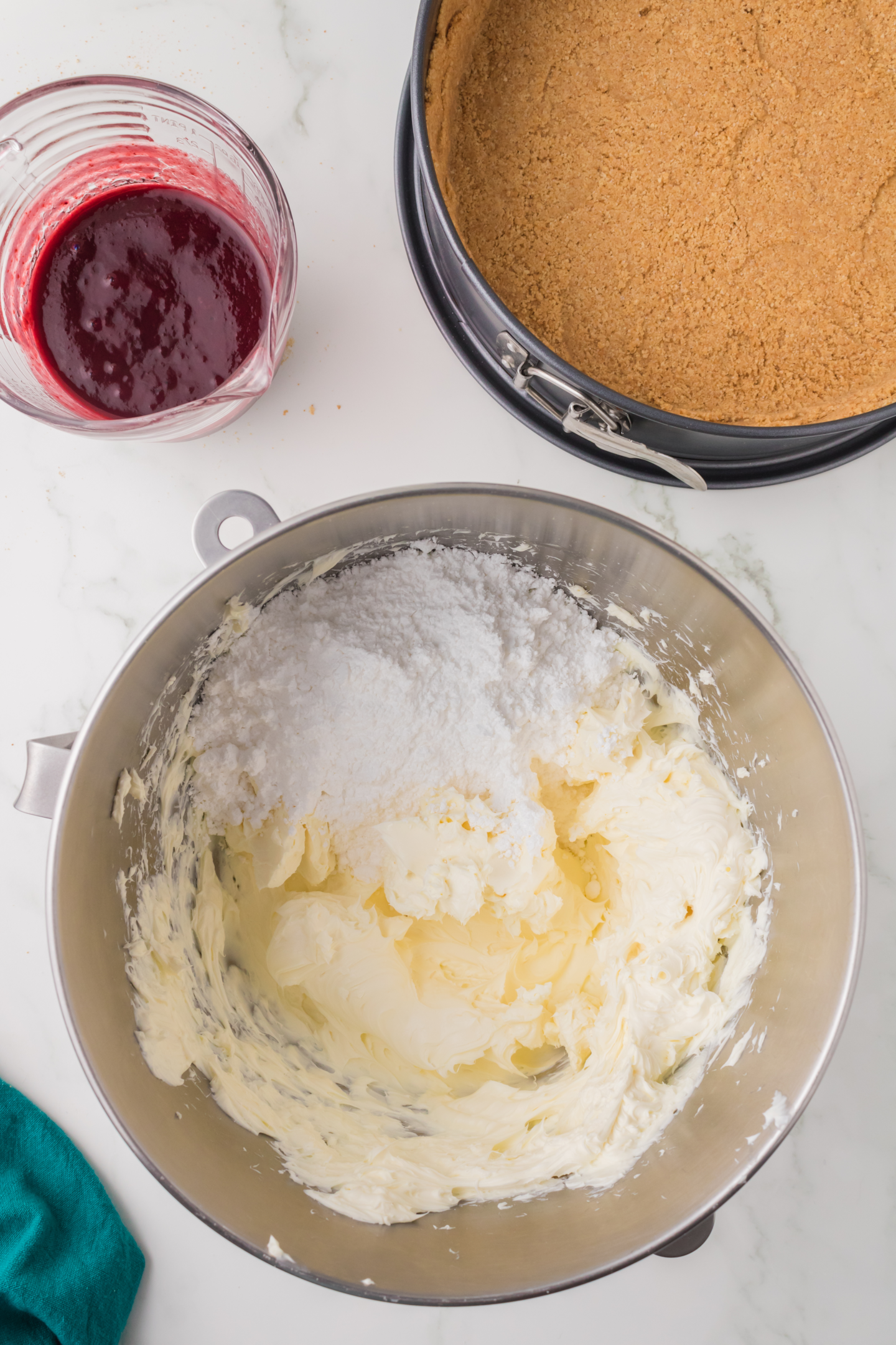 powdered sugar added to beaten cream cheese mixture in bowl