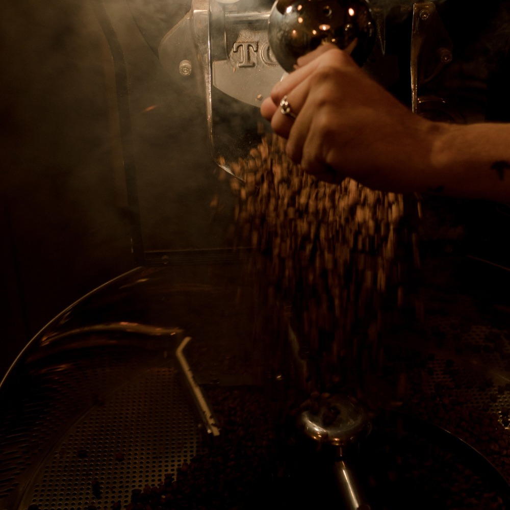 A person setting up a coffee roasting