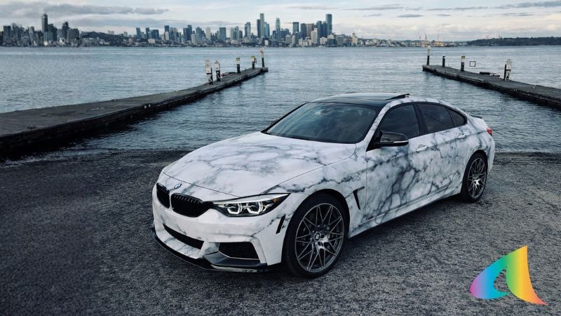 A car wrapped in tie-die print vinyl wrap by Alwan Wraps