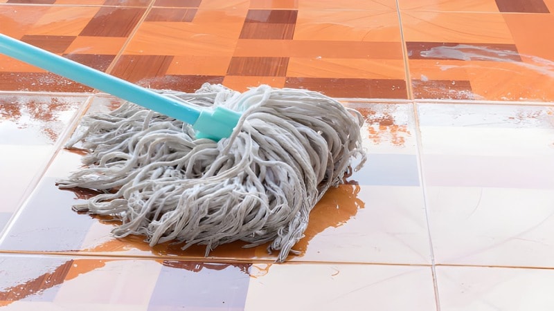 mopping floor with wet mop