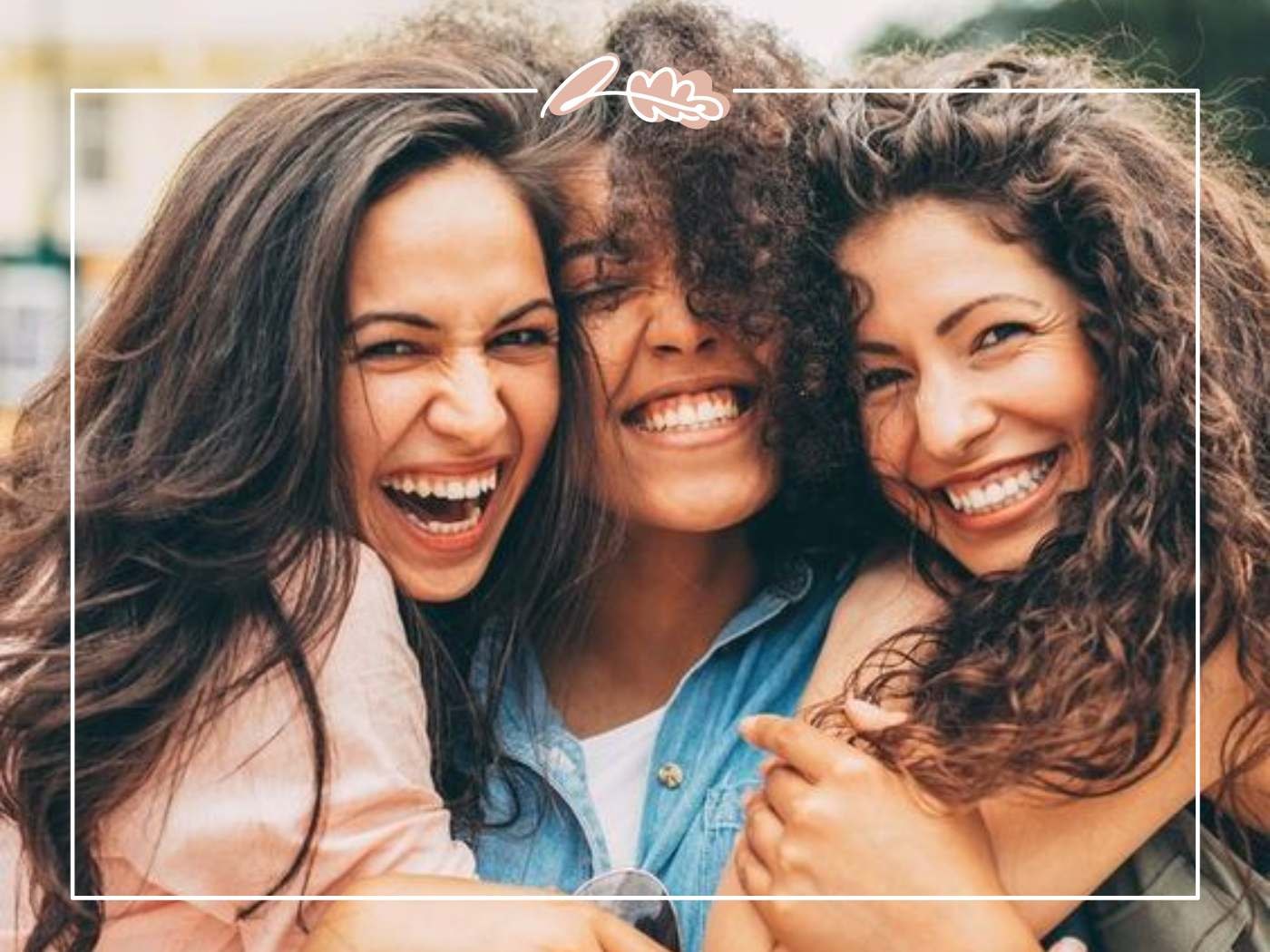 Three friends laughing joyfully together, capturing the essence of happiness and friendship.