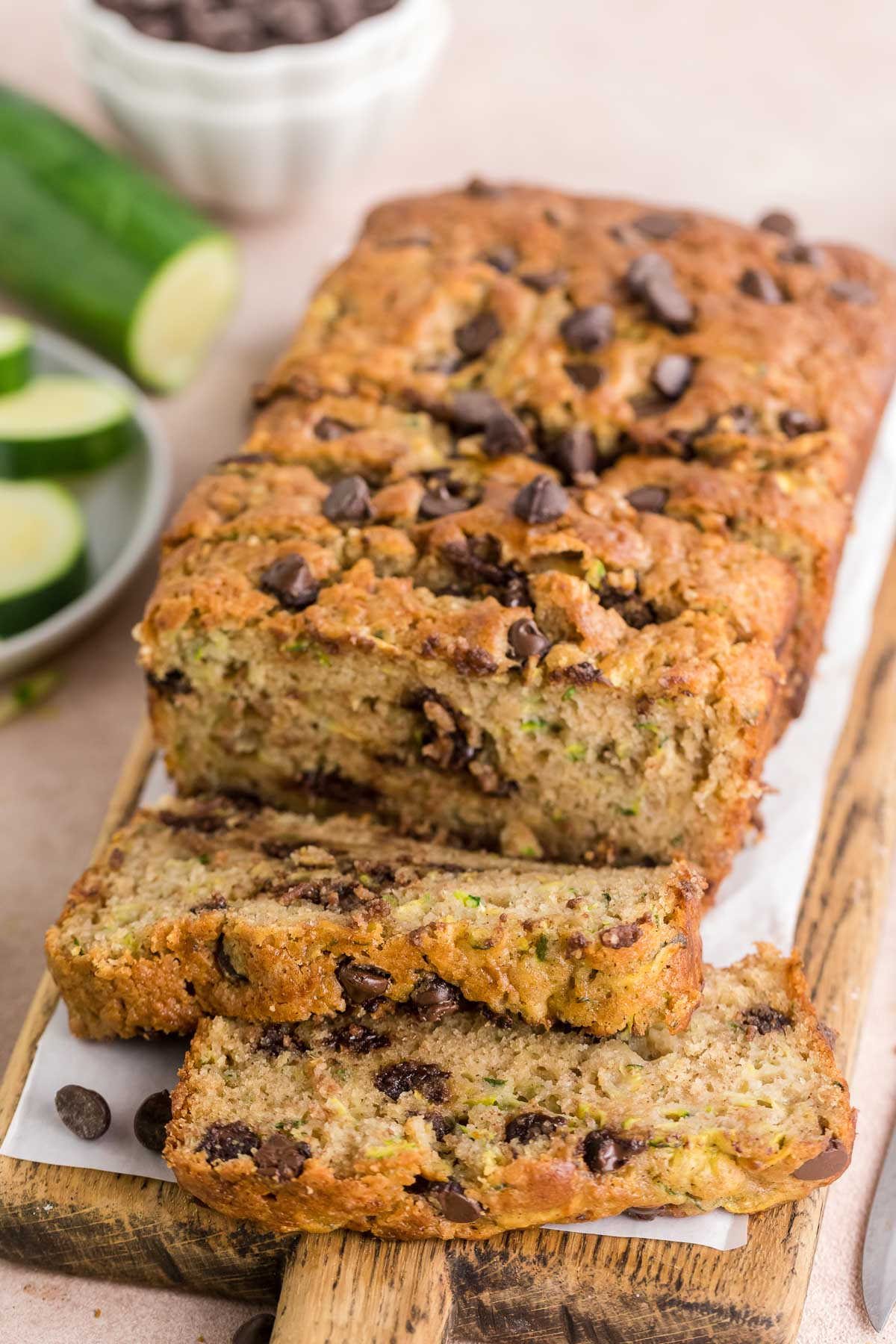 sliced chocolate chip zucchini bread on a wooden cutting board